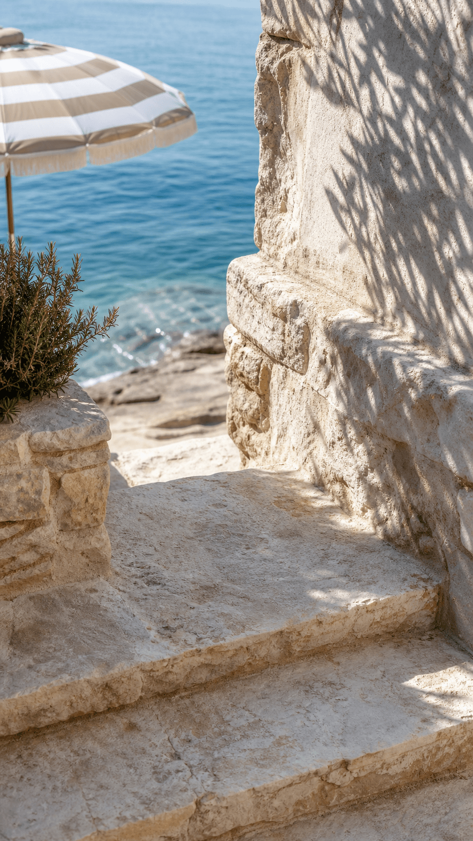 Sunlit limestone steps leading toward the sea